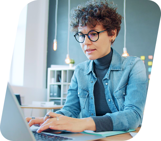 Woman typing on the computer looking for AMS software